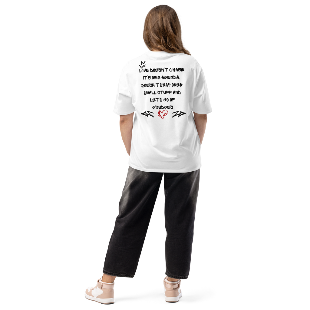 White oversized street tee with graffiti-style lettering on the back, and raw, hand-tagged "Love is in the Air" artwork on the front. A bold statement in urban fashion.