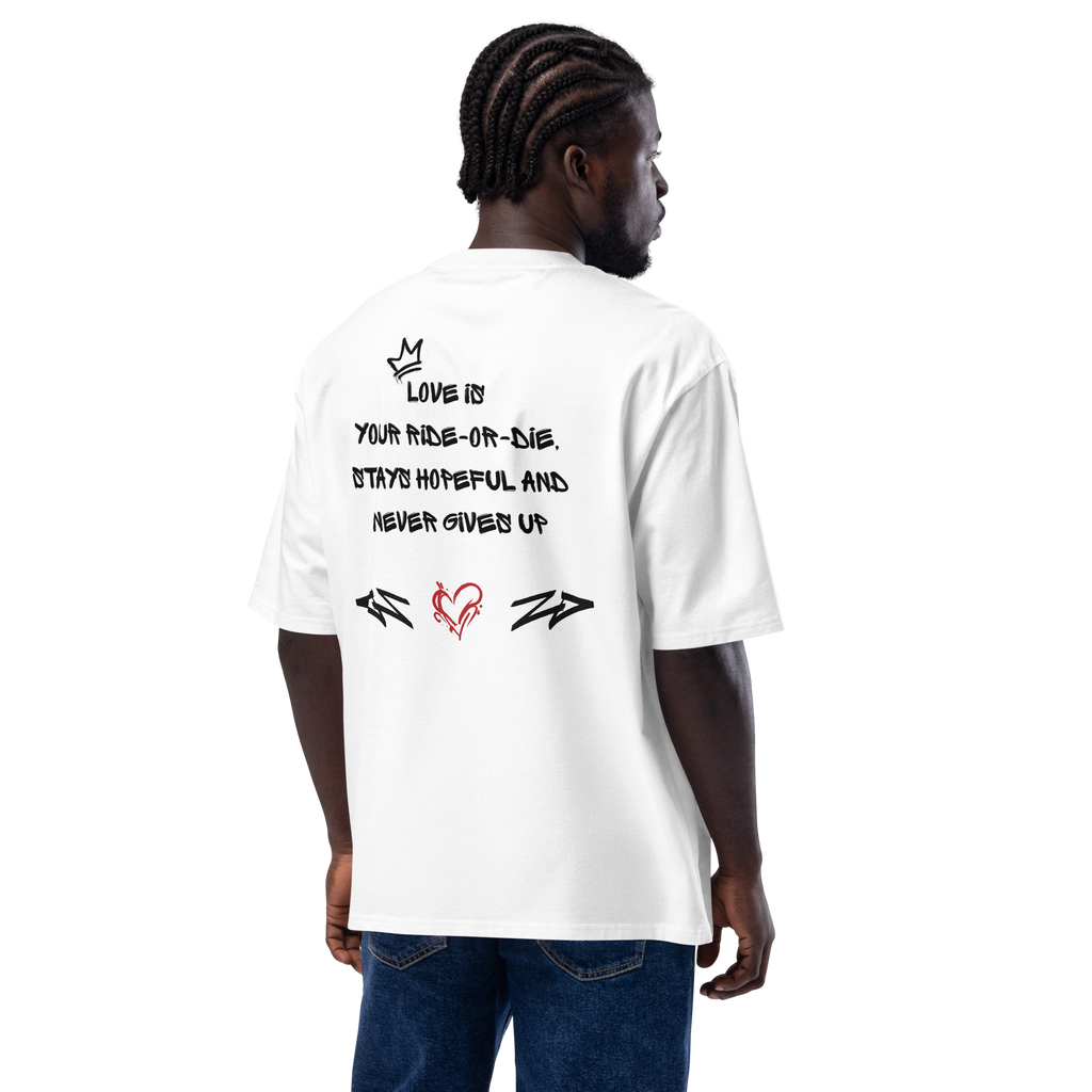 White oversized t-shirt with bold graffiti-style artwork featuring "Love is in the Air" tagging. A raw, urban design celebrating loyalty, love, and commitment.