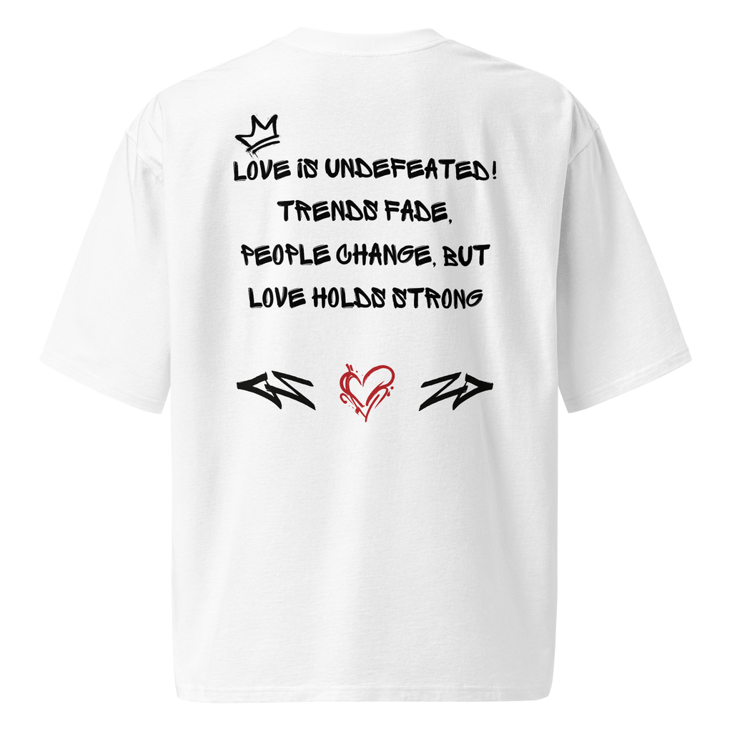 A white oversized tee with graffiti-tag lettering on the back and "Love is in the Air" artwork on the front. Streetwear-inspired, bold, and built to last.