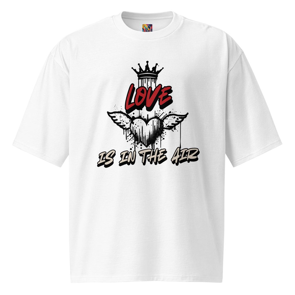 White oversized t-shirt with bold graffiti-style artwork featuring "Love is in the Air" tagging. A raw, urban design celebrating loyalty, love, and commitment.