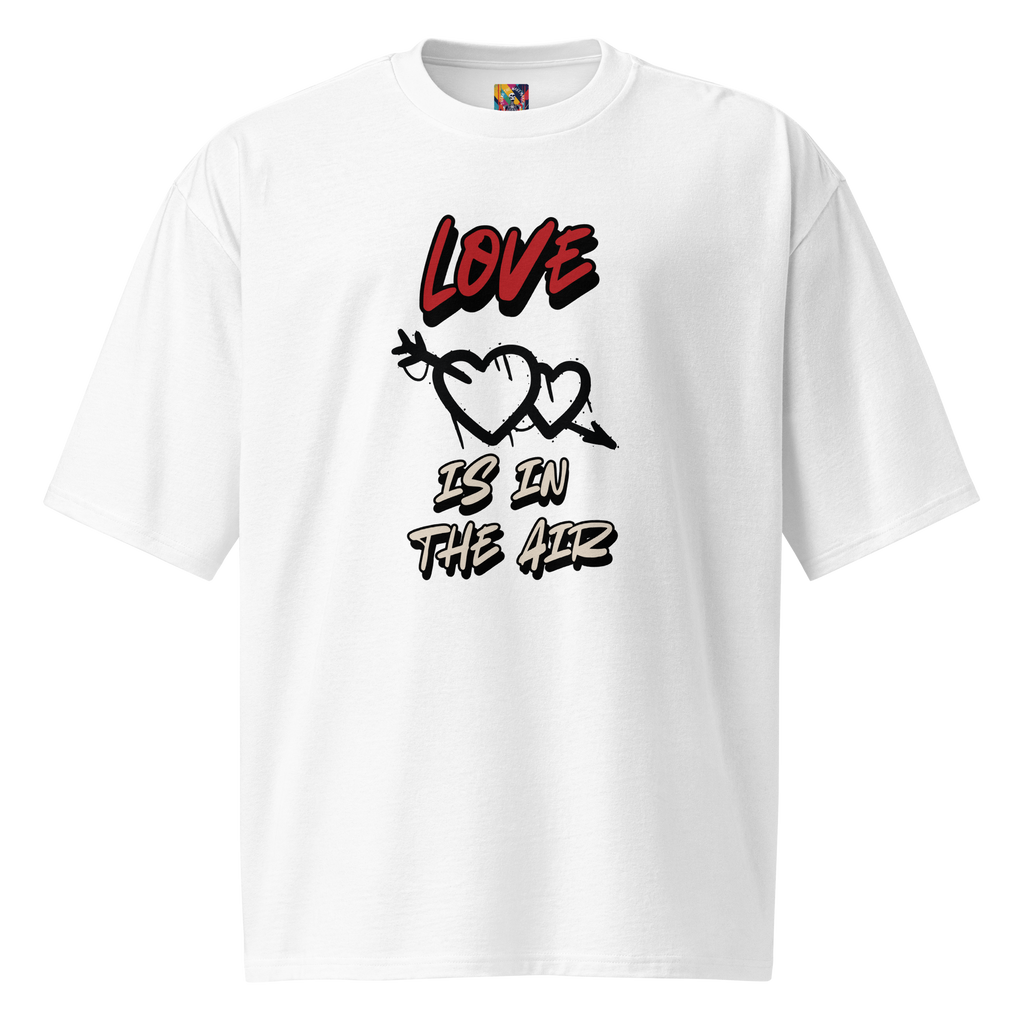 A white oversized tee with graffiti-tag lettering on the back and "Love is in the Air" artwork on the front. Streetwear-inspired, bold, and built to last.